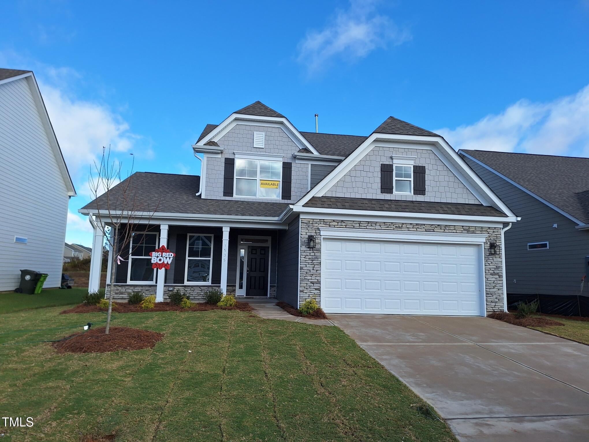 a front view of a house with garage