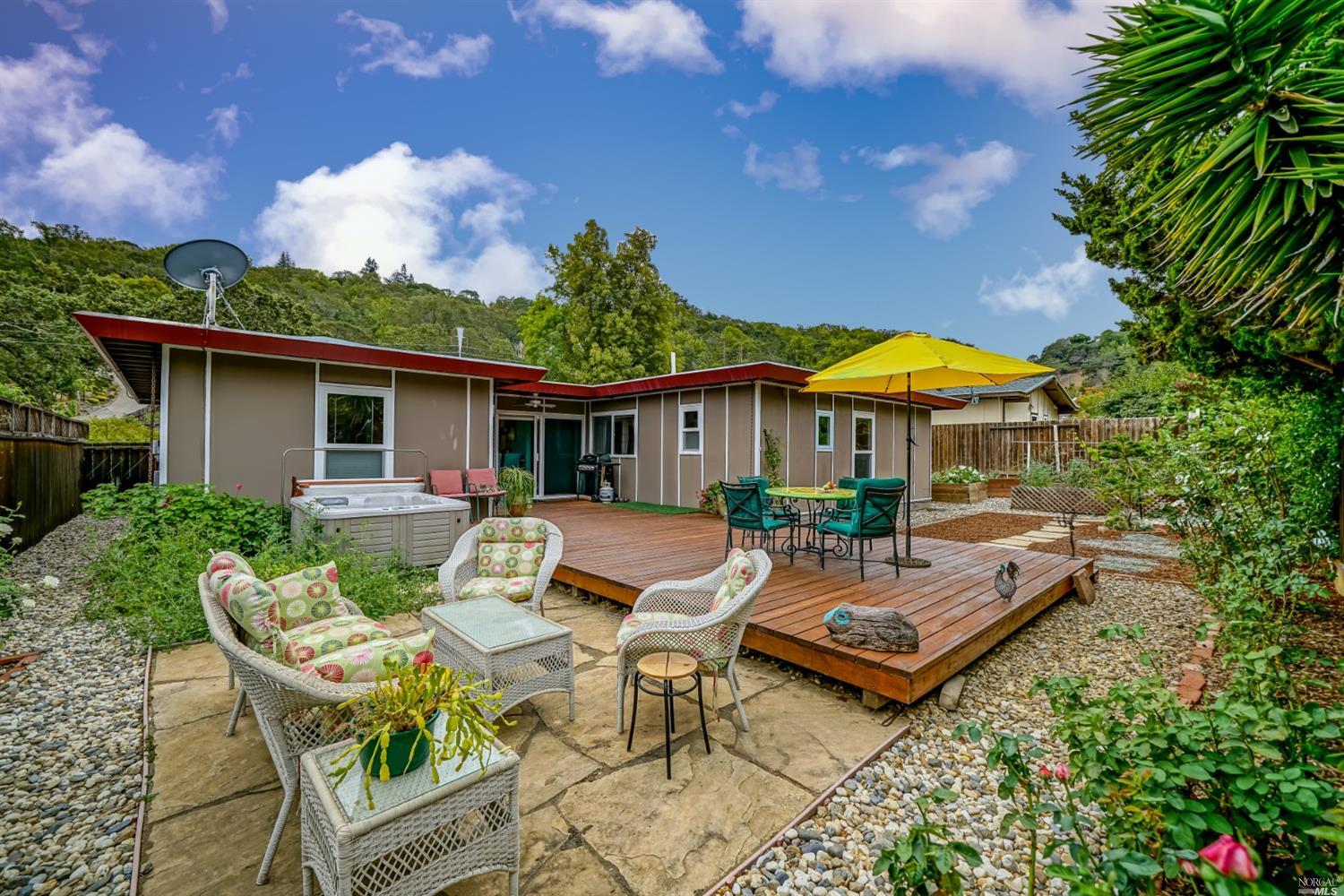 a view of a house with backyard sitting area and garden