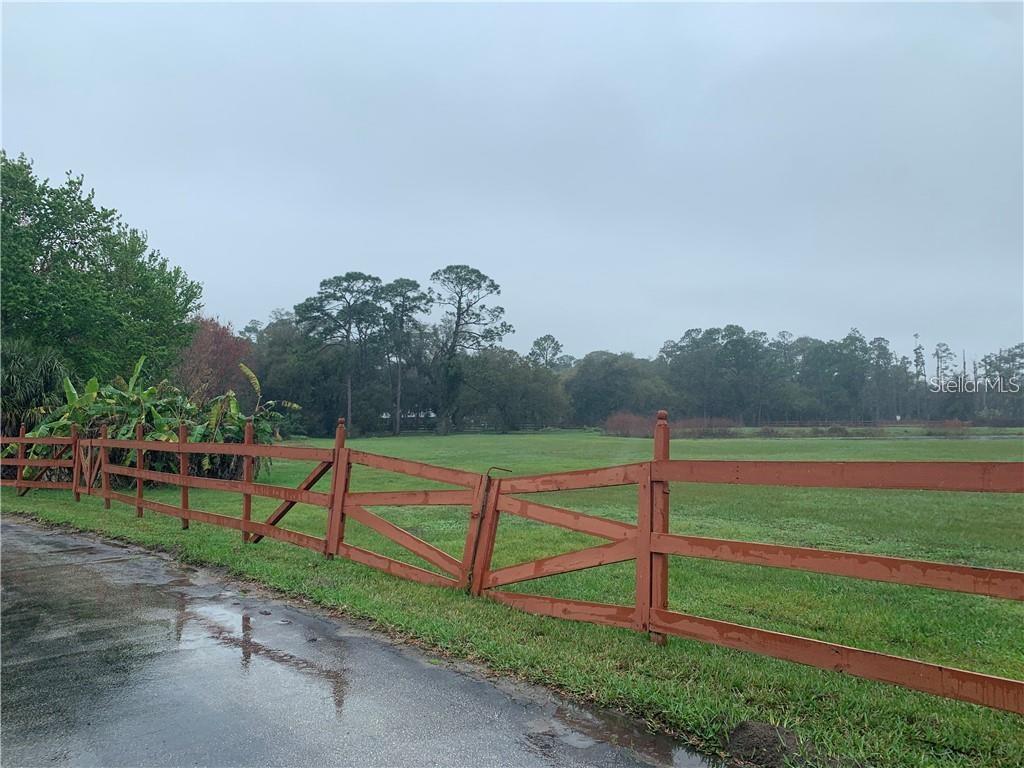 a view of park with wooden fence