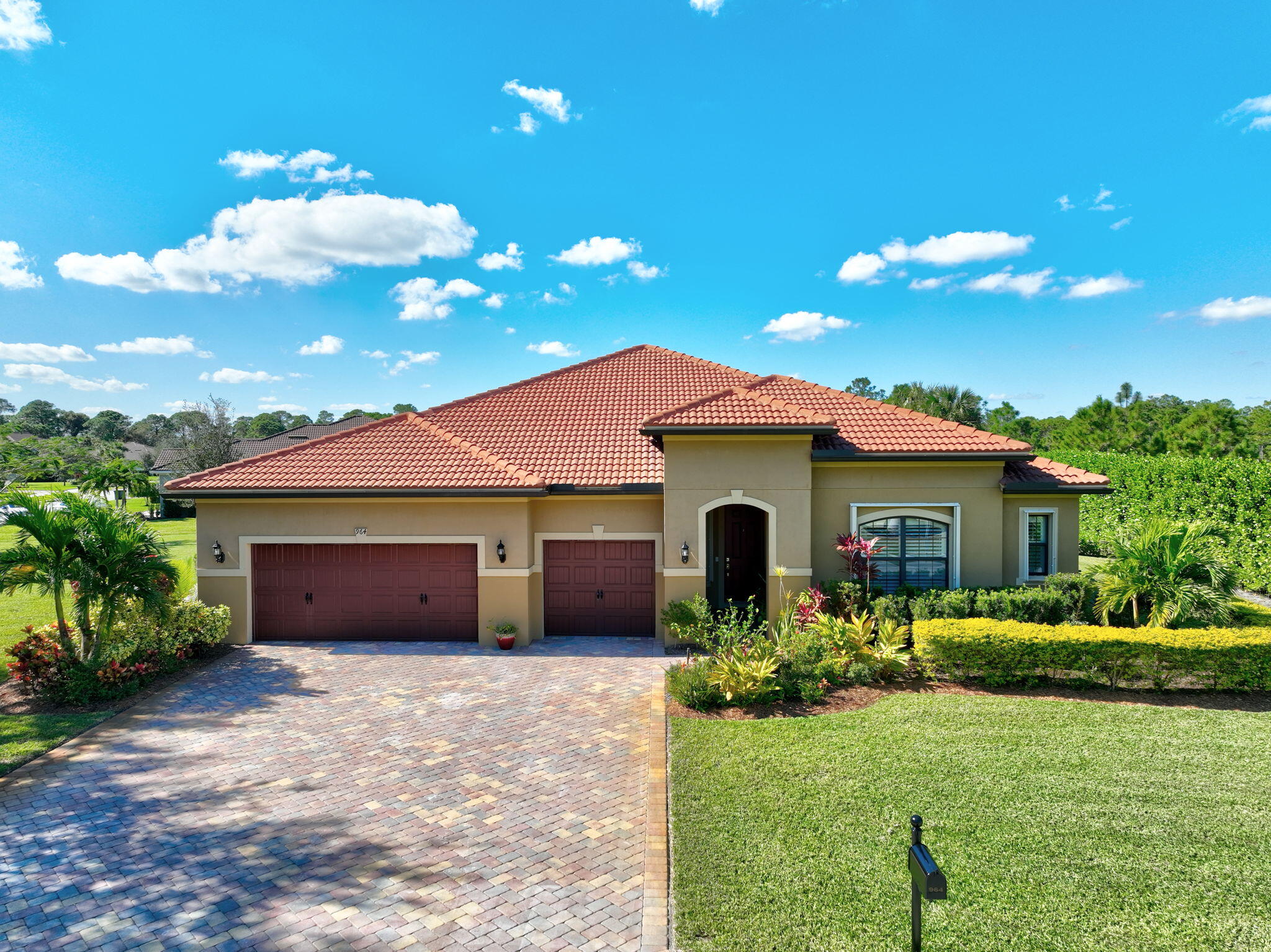 a front view of house with yard and garage