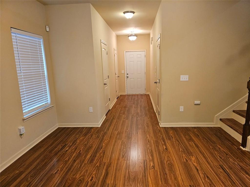 a view of a room with wooden floor and a sink