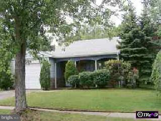 a view of a house with a yard and potted plants