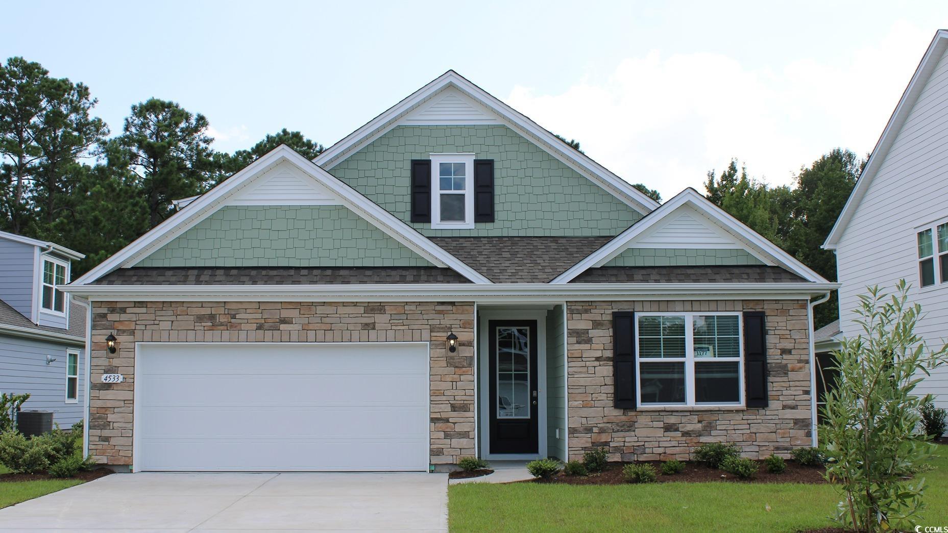 Craftsman-style house featuring a garage