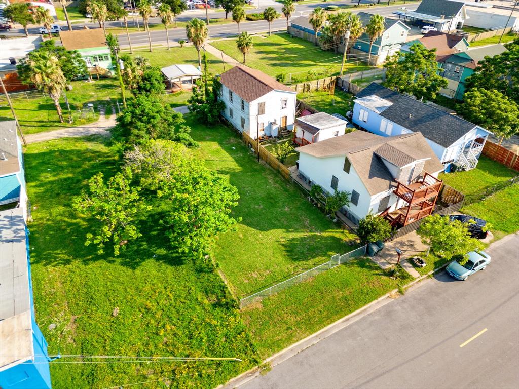 an aerial view of residential houses with outdoor space and street view