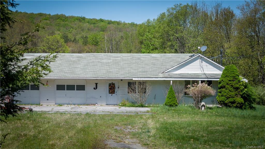 a house with green field in front of it