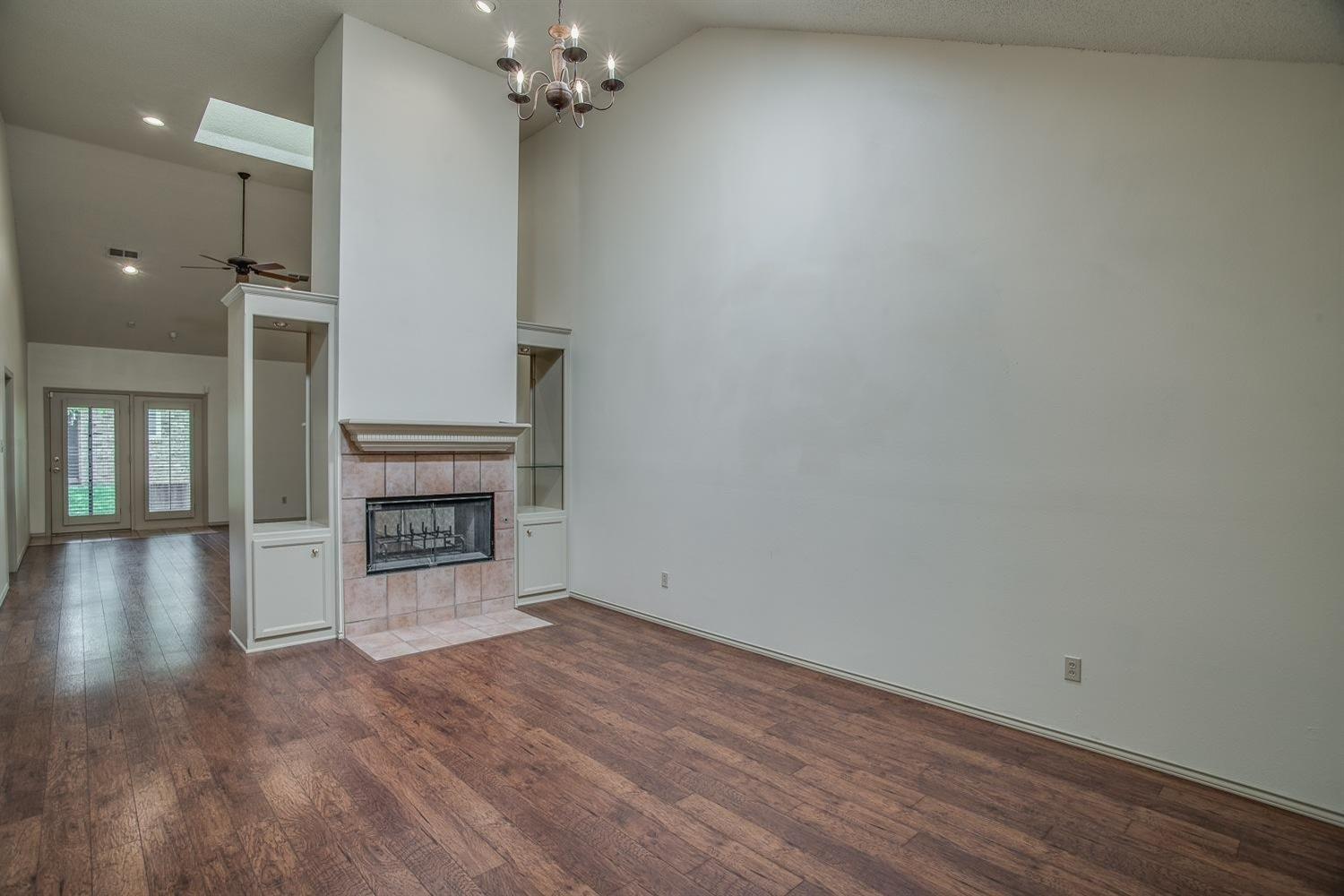 wooden floor in an empty room with a fireplace