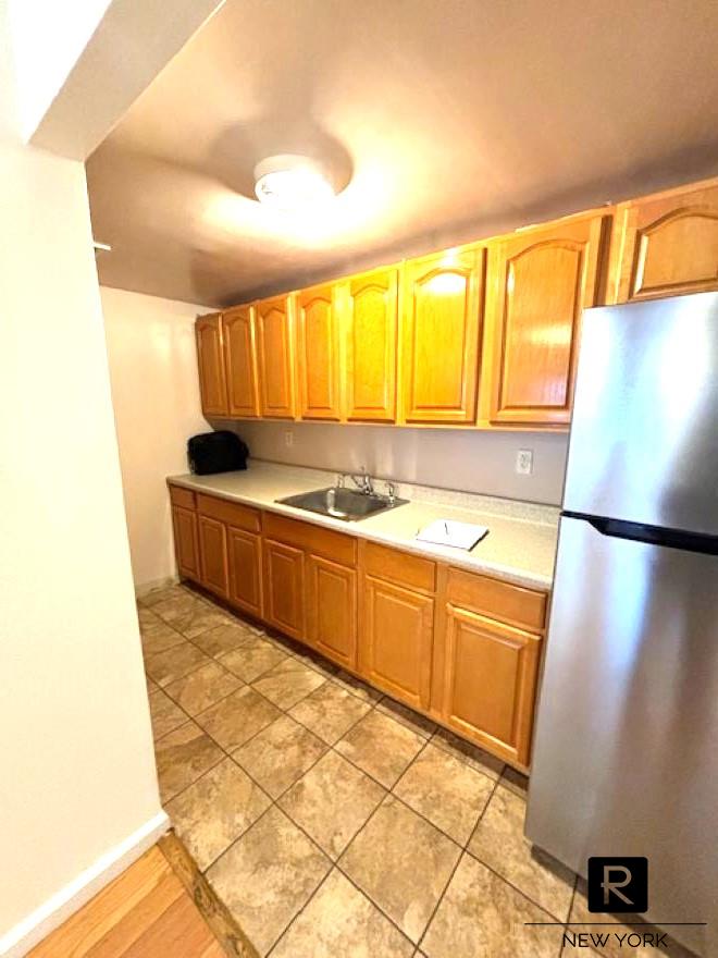 a kitchen with stainless steel appliances granite countertop a refrigerator and a sink