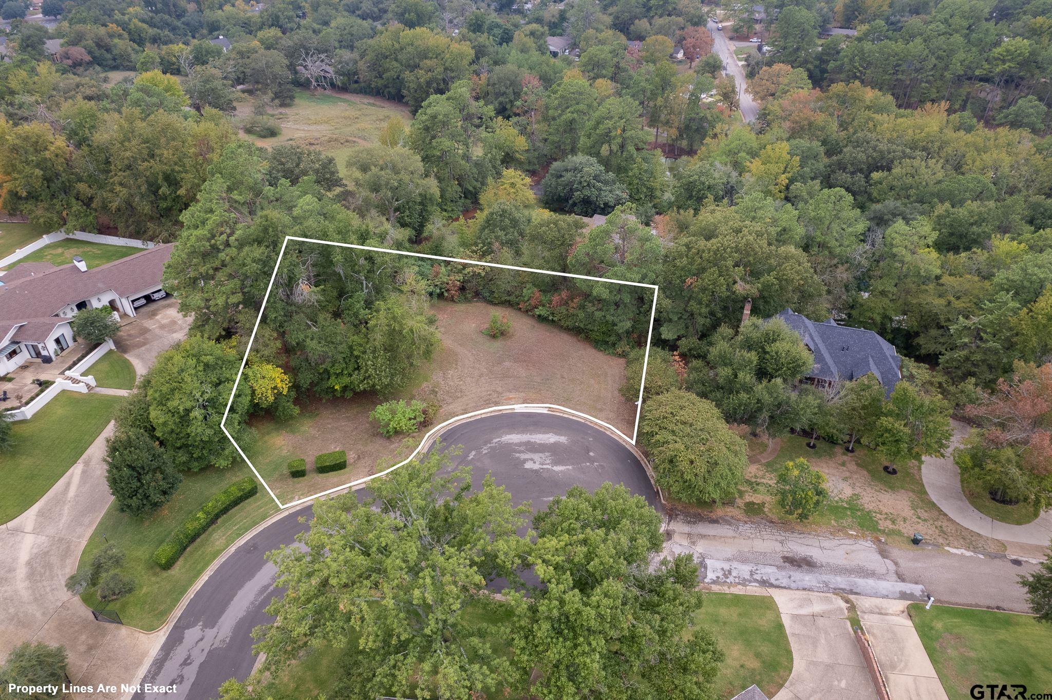 an aerial view of a house with backyard