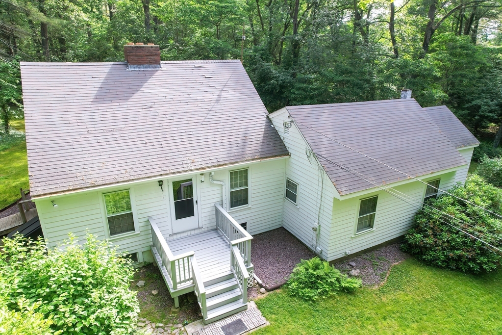 an aerial view of a house with a yard and potted plants