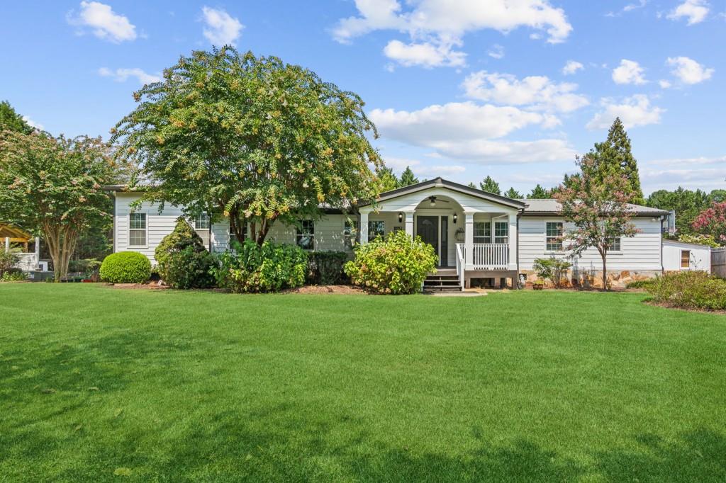 a front view of a house with a garden