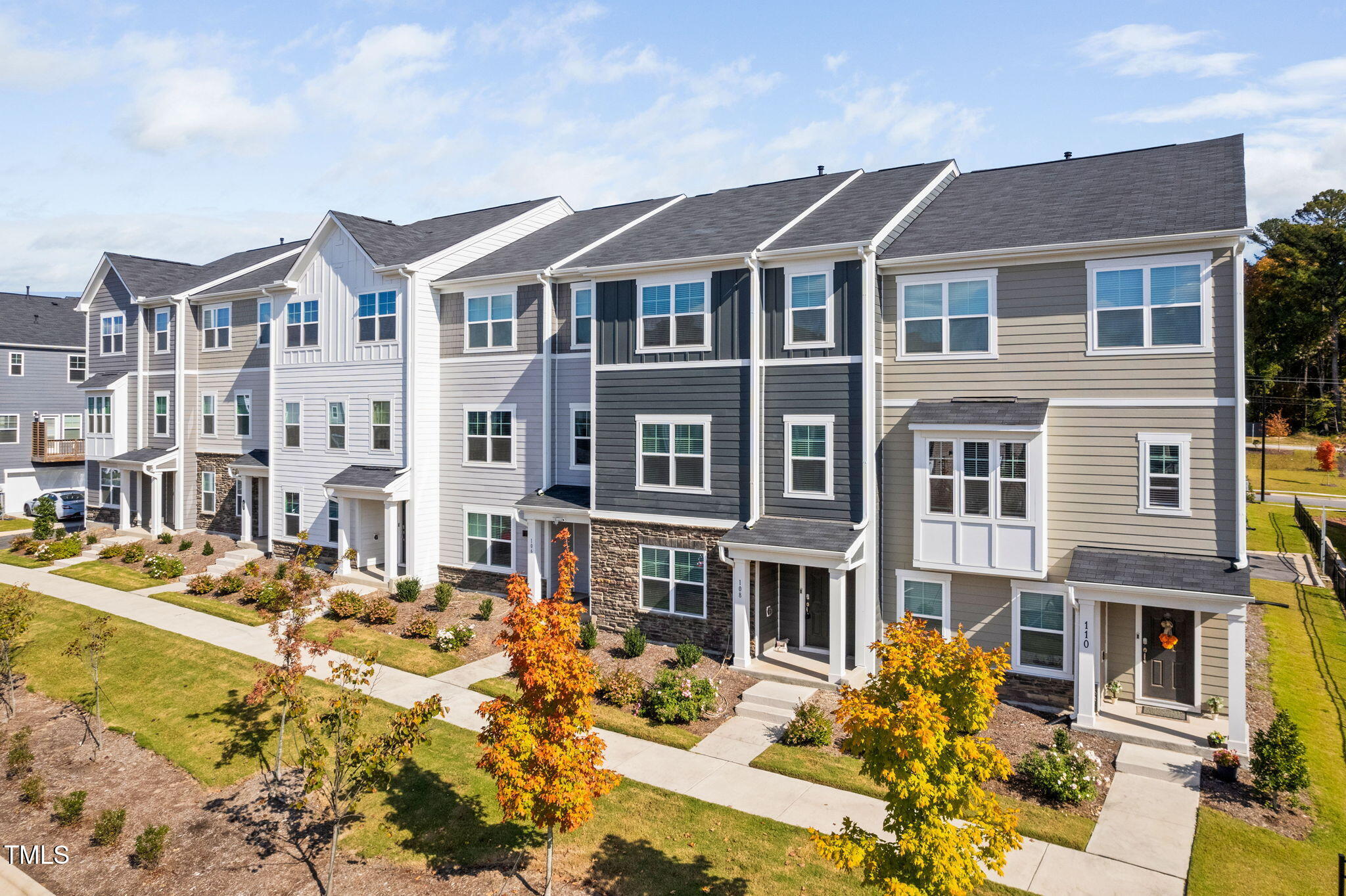 a front view of a residential apartment building with a yard