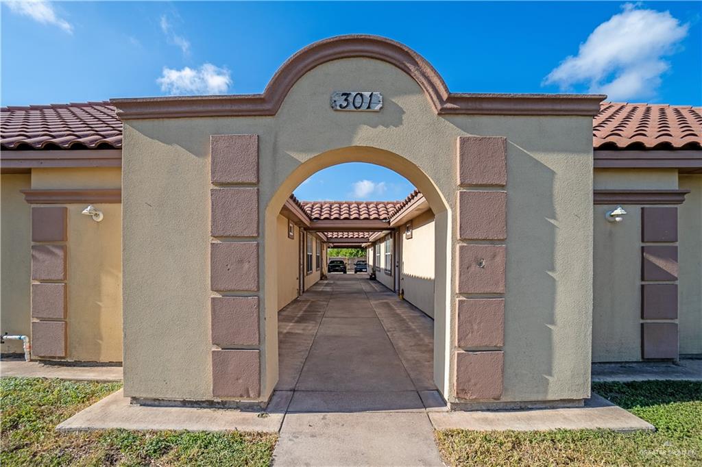 a view of a brick house with a door and a outdoor space