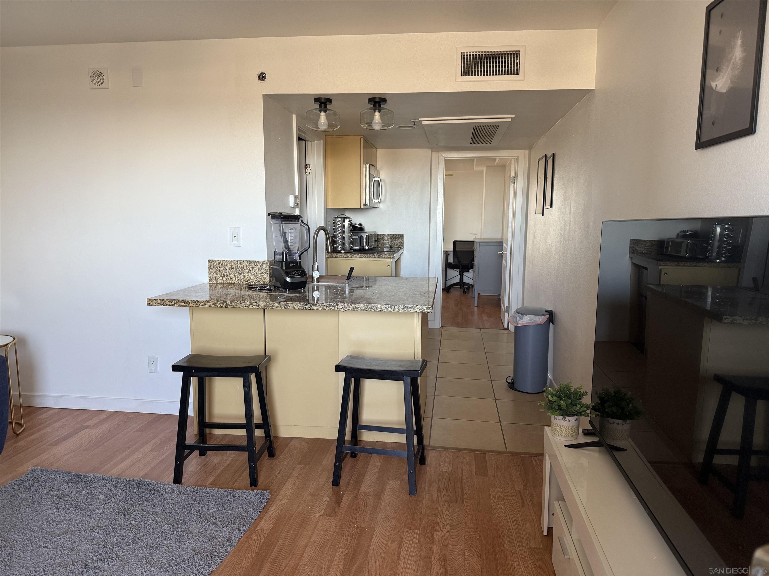 a dining room with furniture and wooden floor