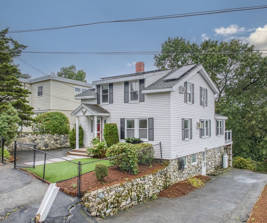 a front view of a house with garden