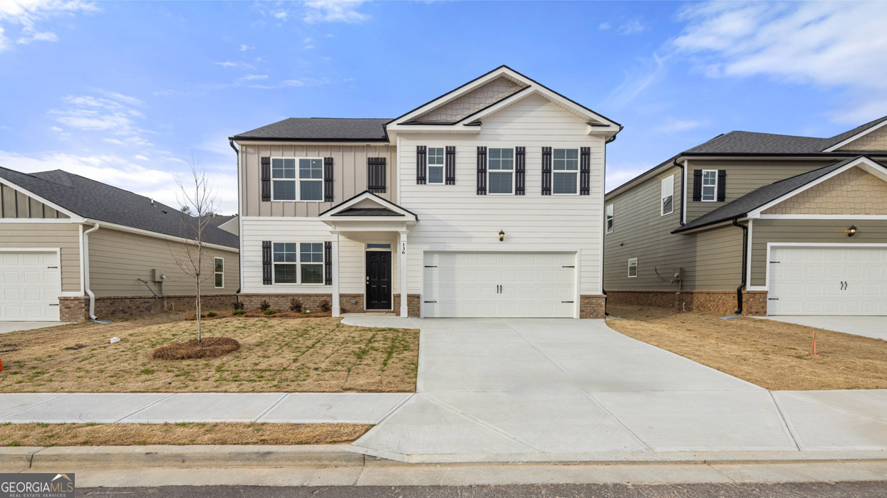 a front view of a house with a yard