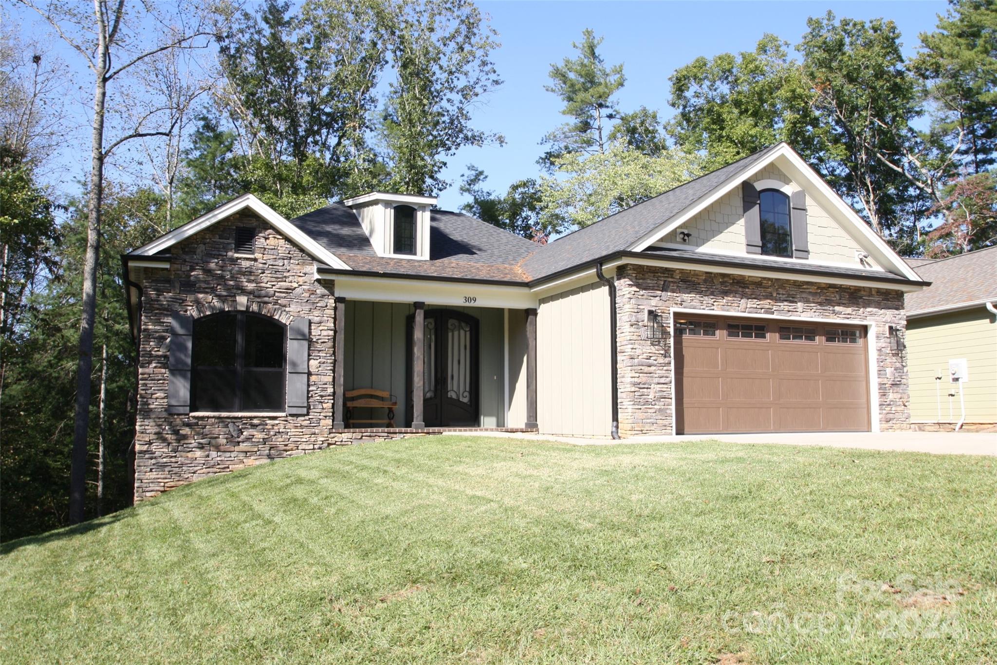 a front view of a house with a yard and garage