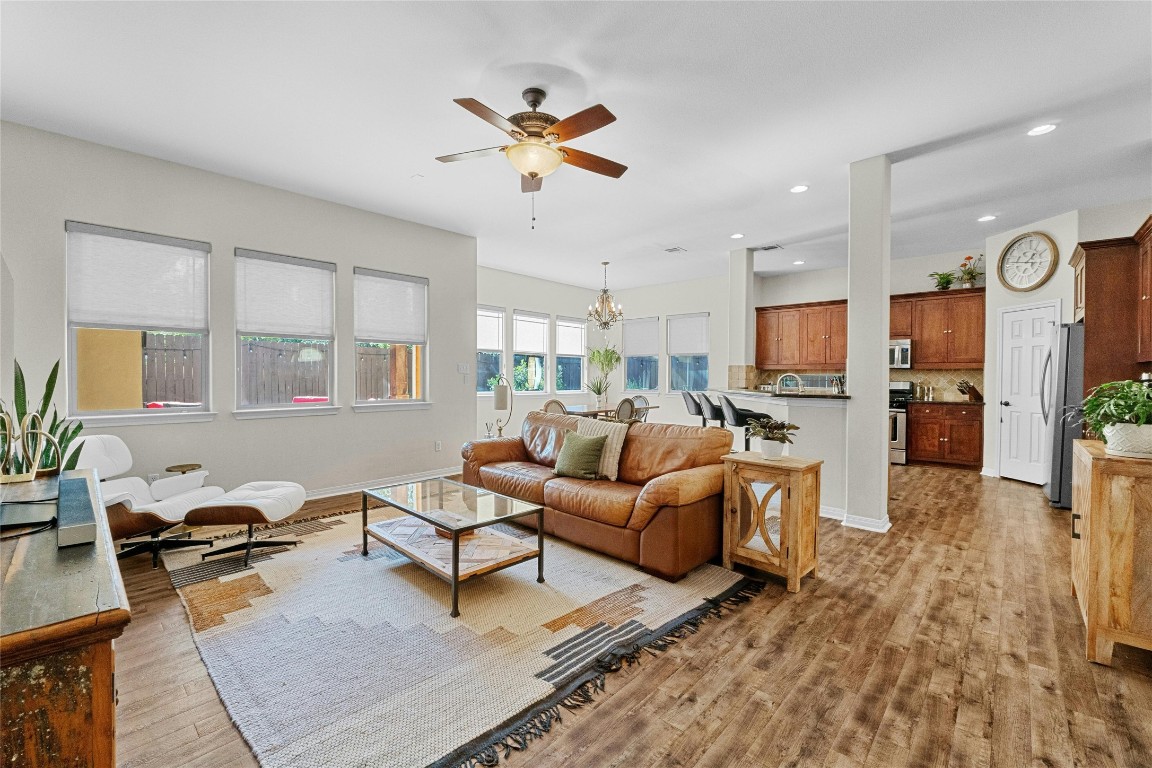 a living room with furniture kitchen view and a window