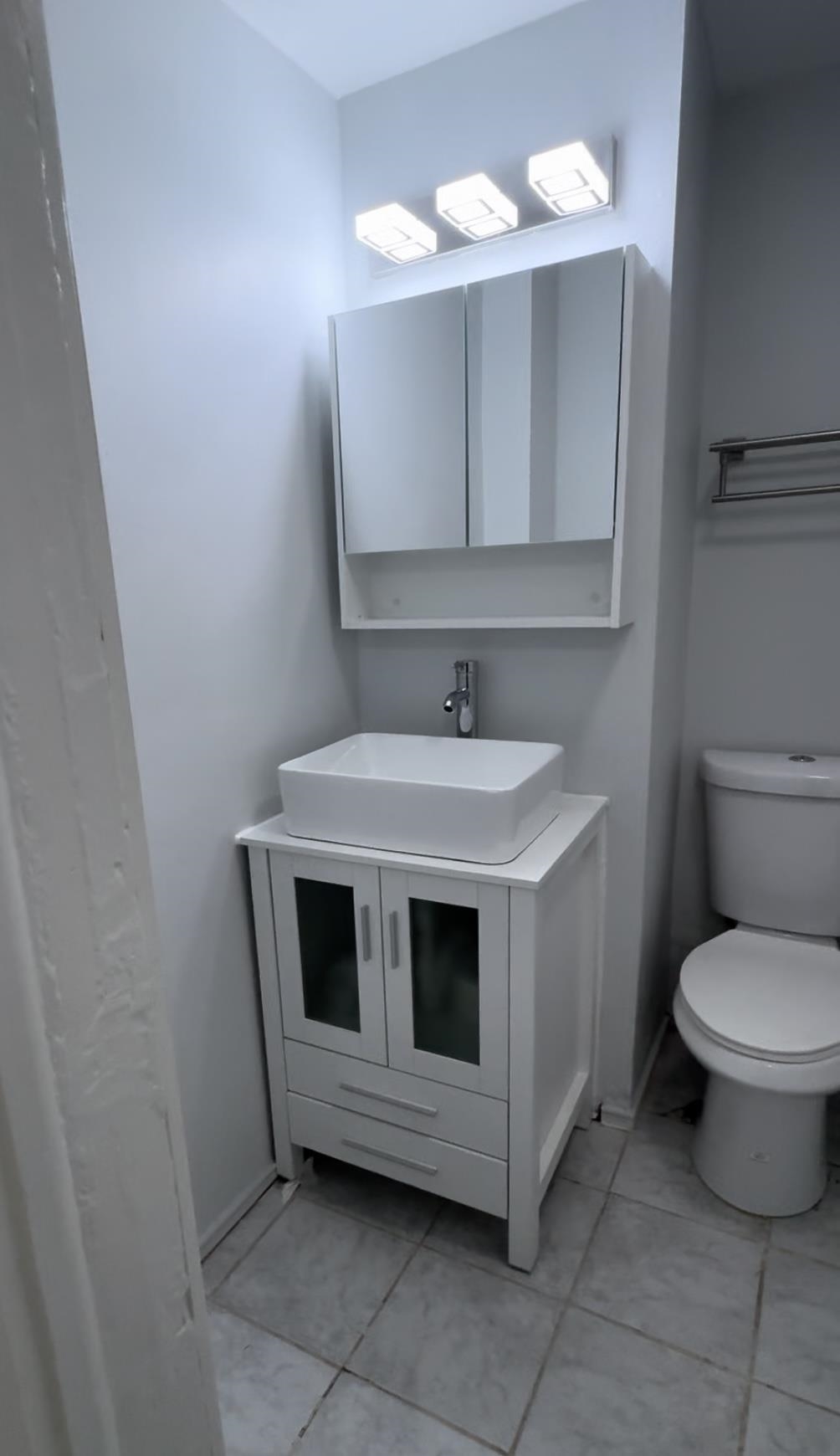 a bathroom with a sink toilet and mirror