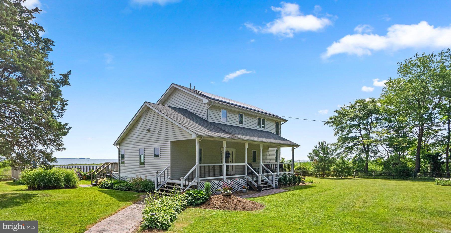 a view of a house with yard and a garden