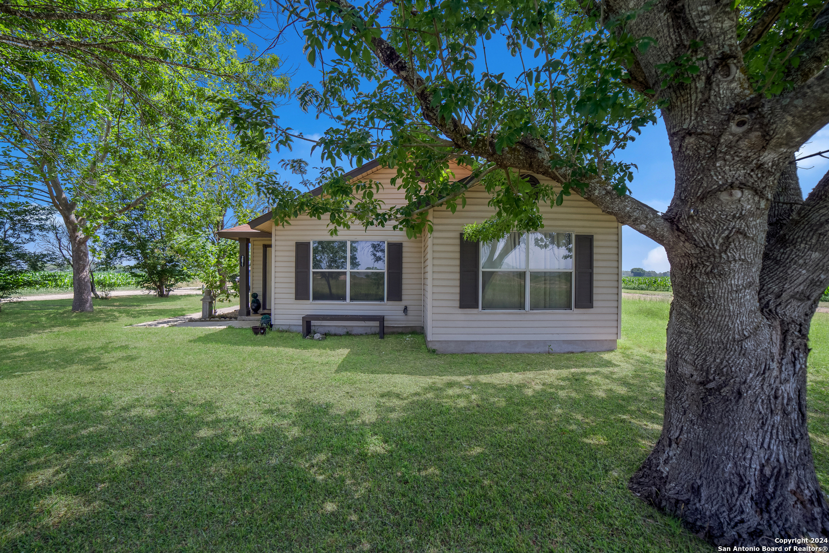 a view of house with backyard porch and garden