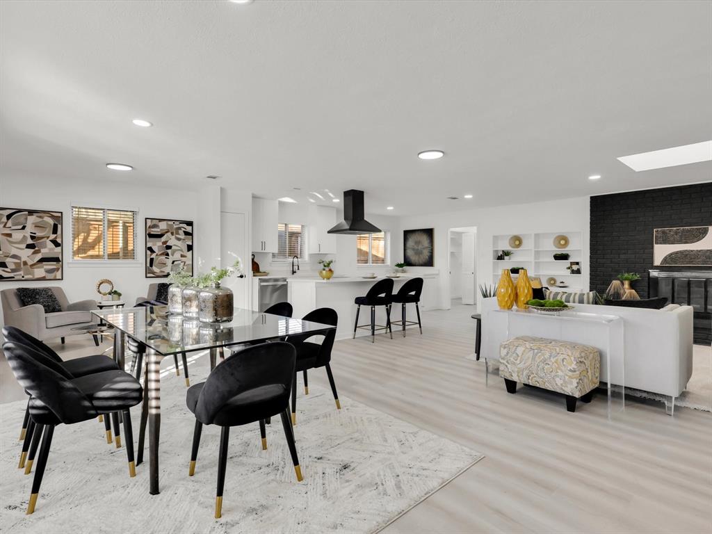 a living room with furniture and a dining table with wooden floor