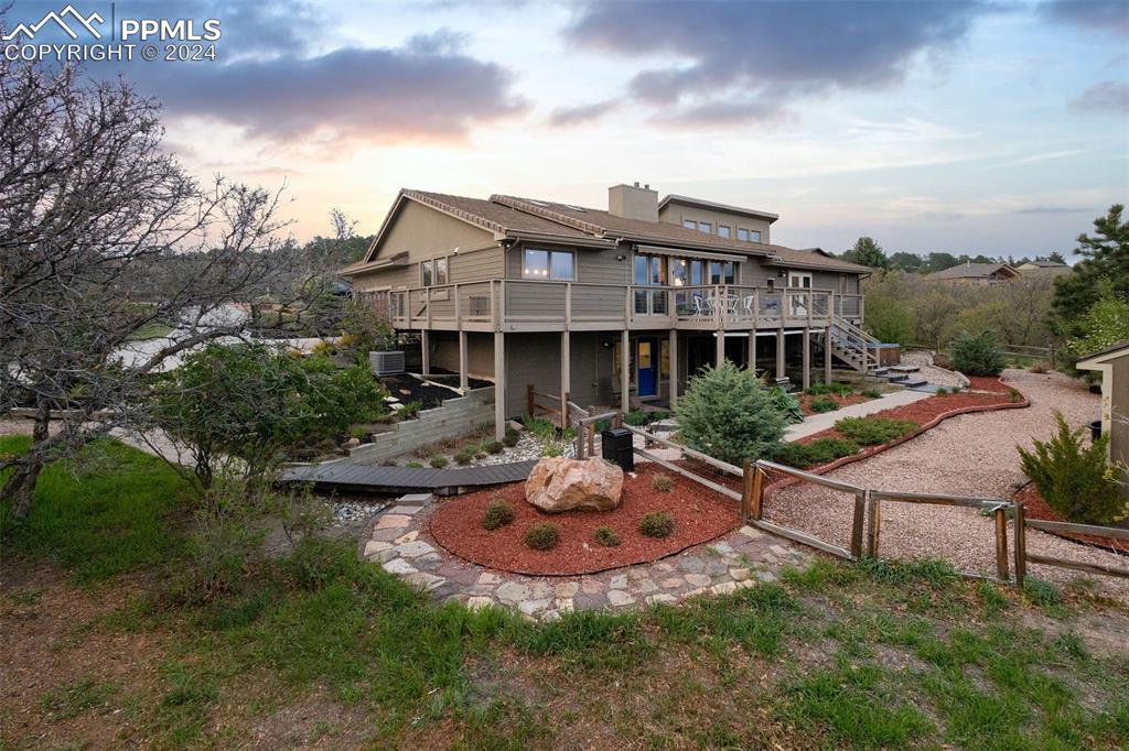 a view of a house with backyard sitting area and garden