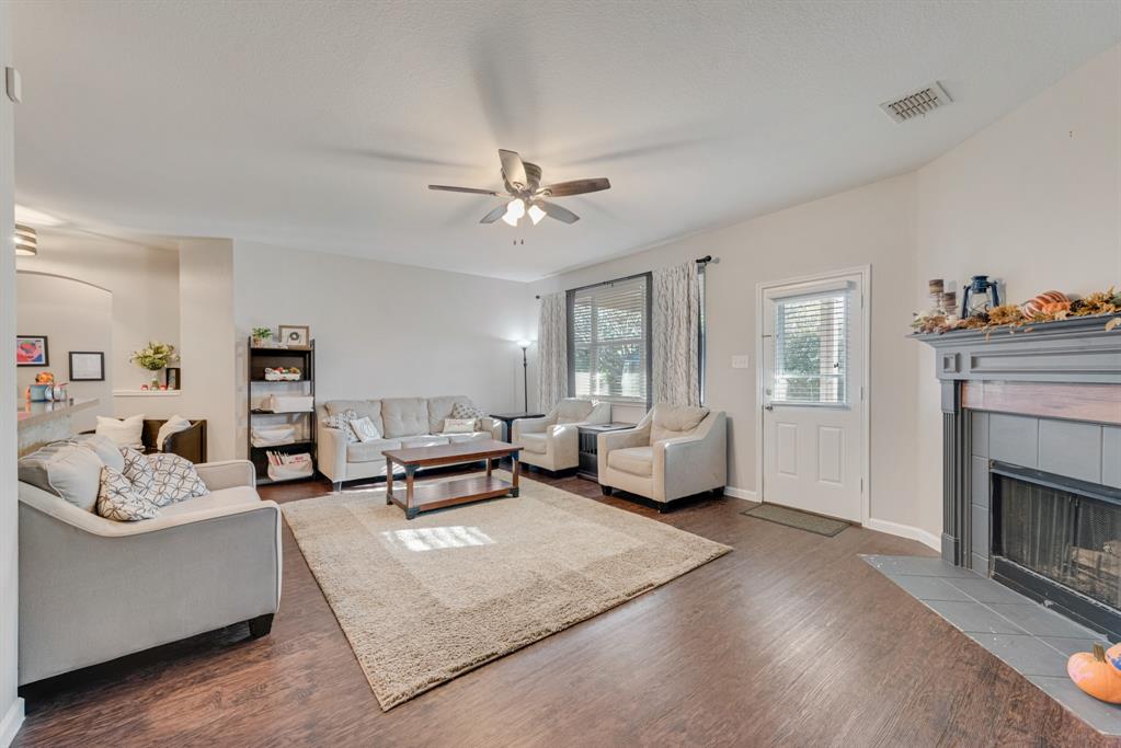 a living room with furniture fireplace and window