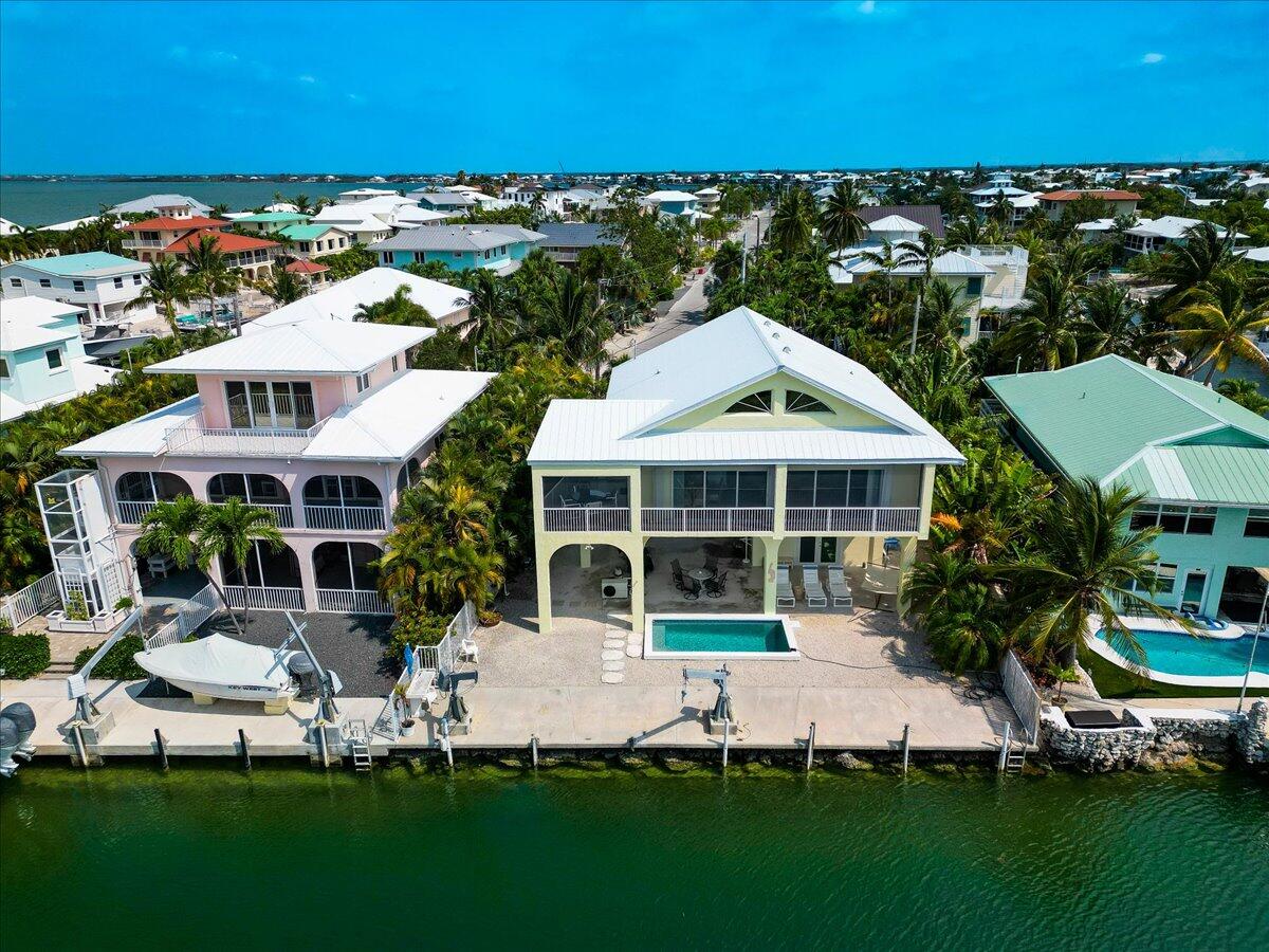 a aerial view of a house with a garden and lake view