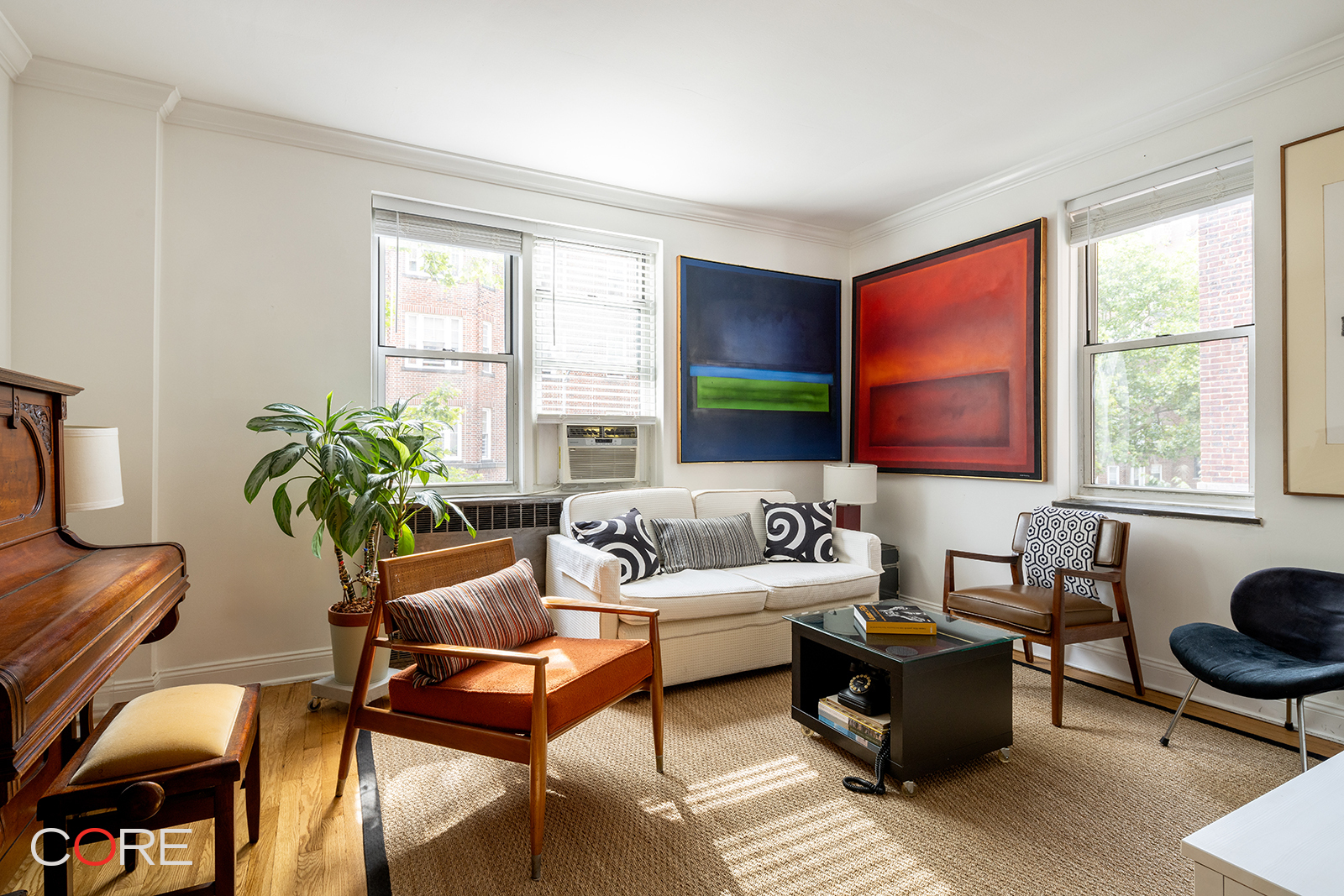 a living room with furniture fireplace and a window