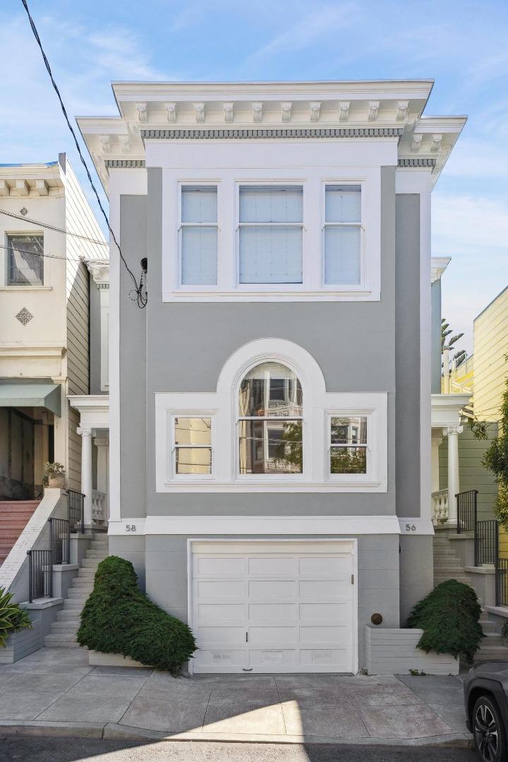 a front view of a house with parking space