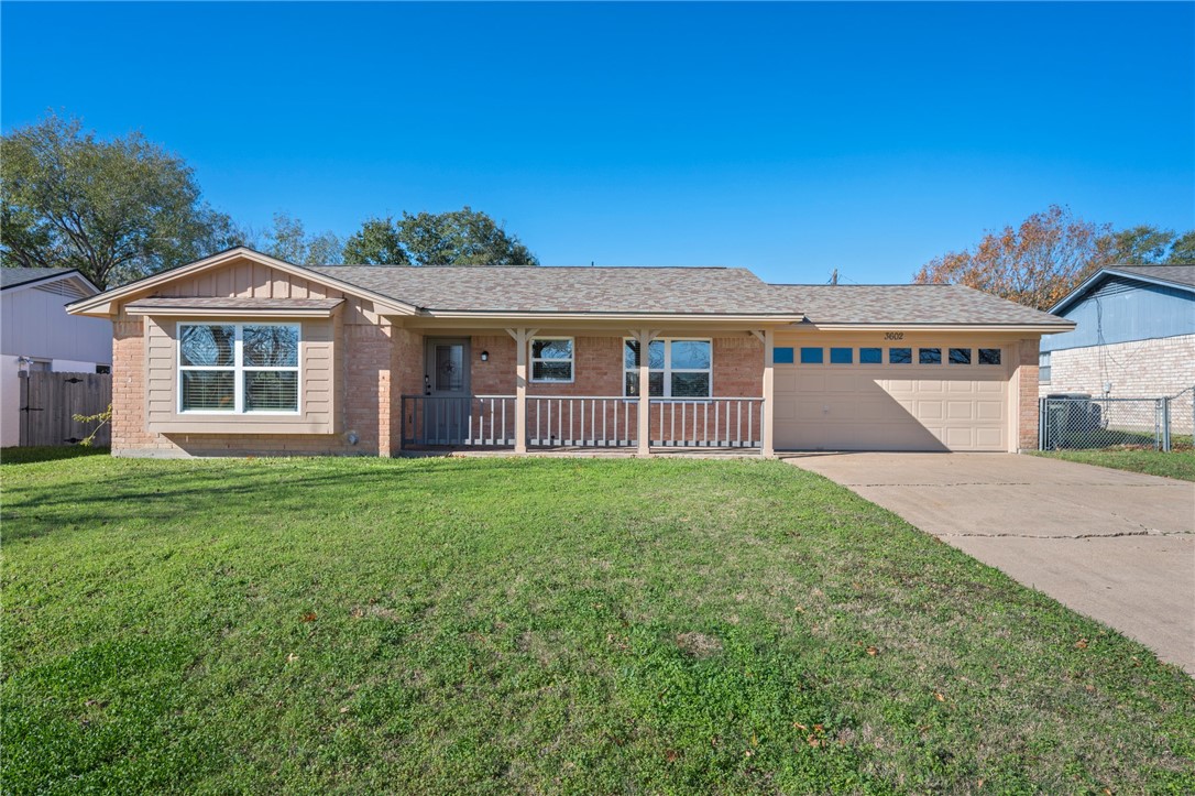 Single story home featuring a front yard, a porch,