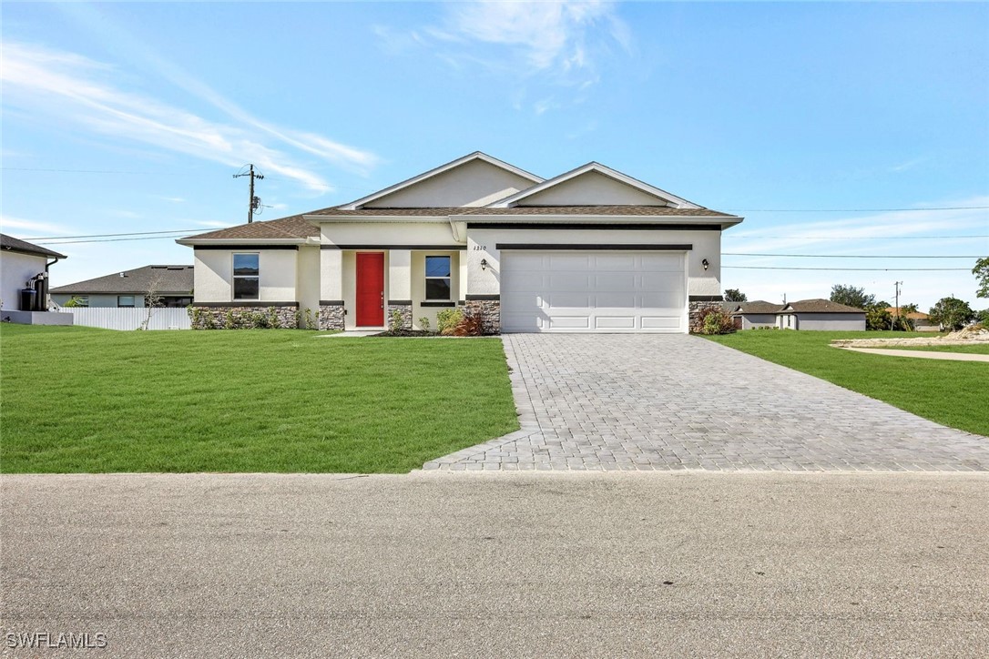 a front view of a house with a yard and garage