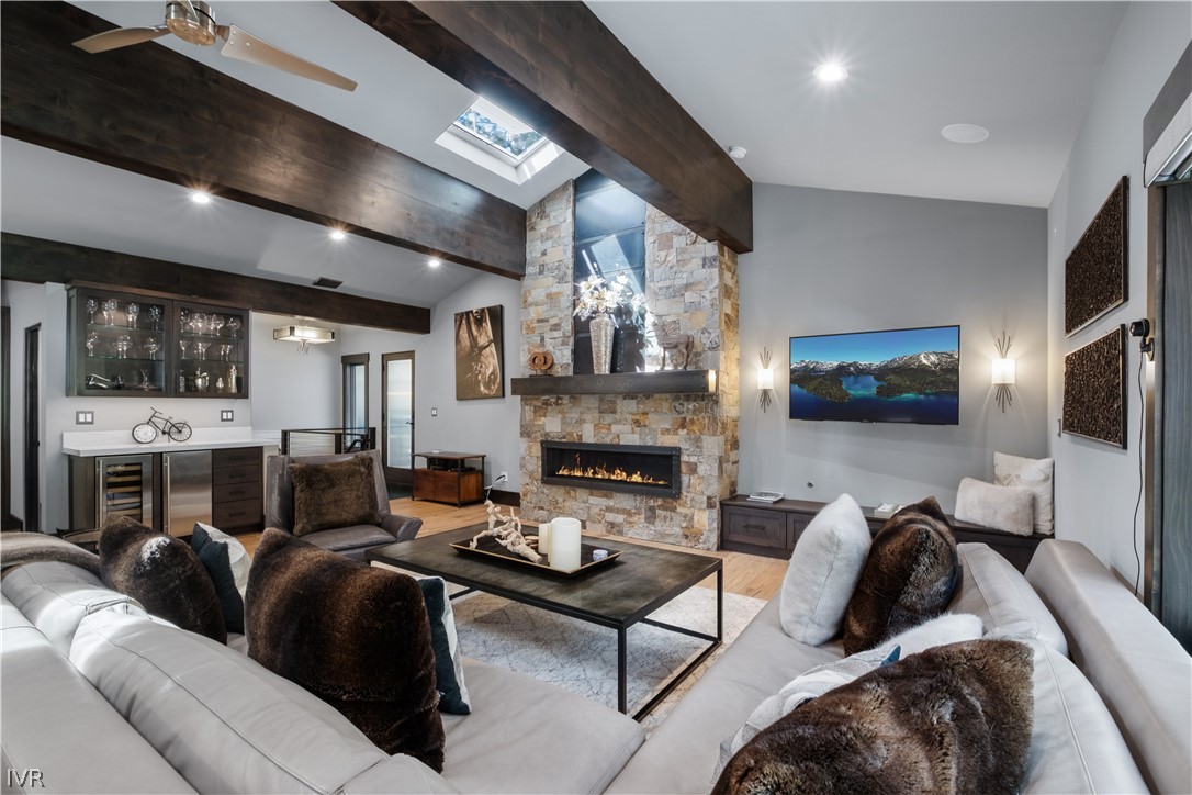 a living room with furniture a fireplace and a flat screen tv