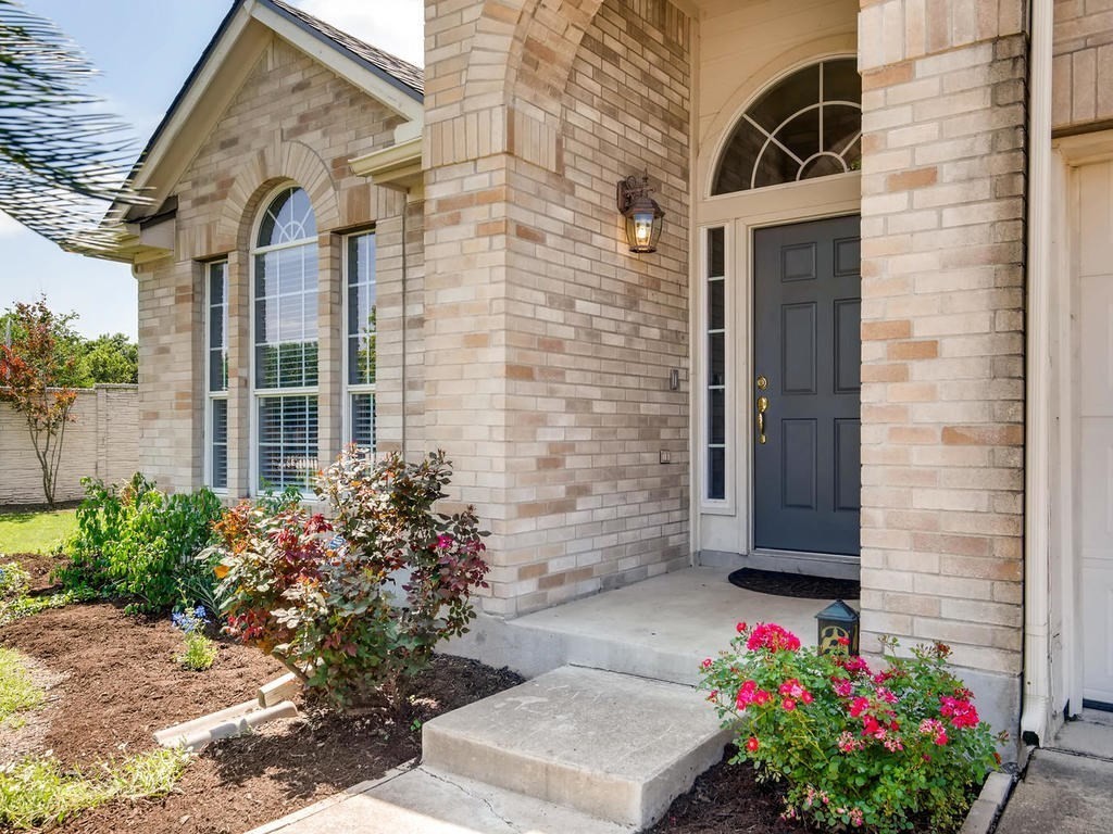 a front view of a house with a garden