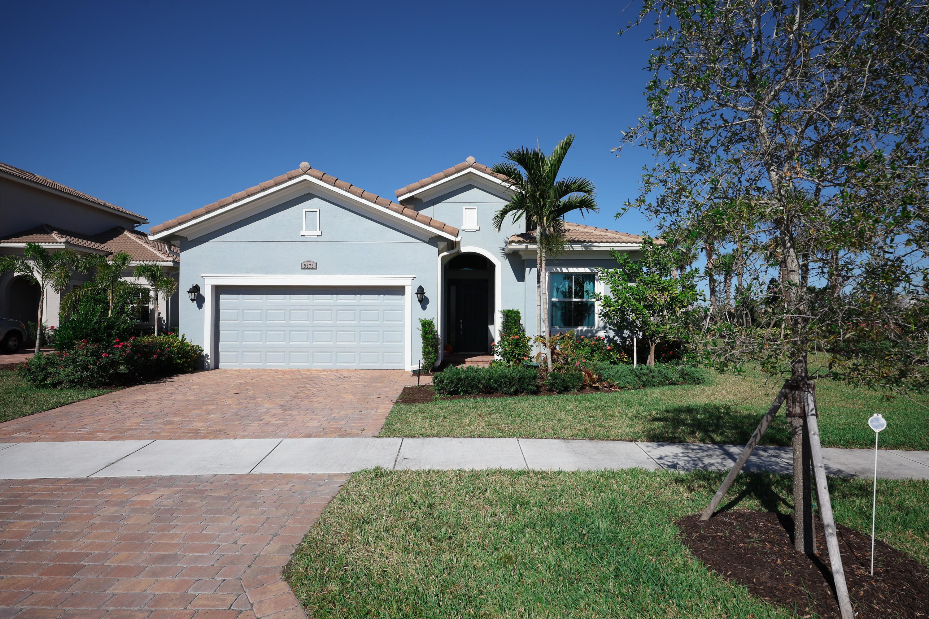 a front view of a house with a yard and garage