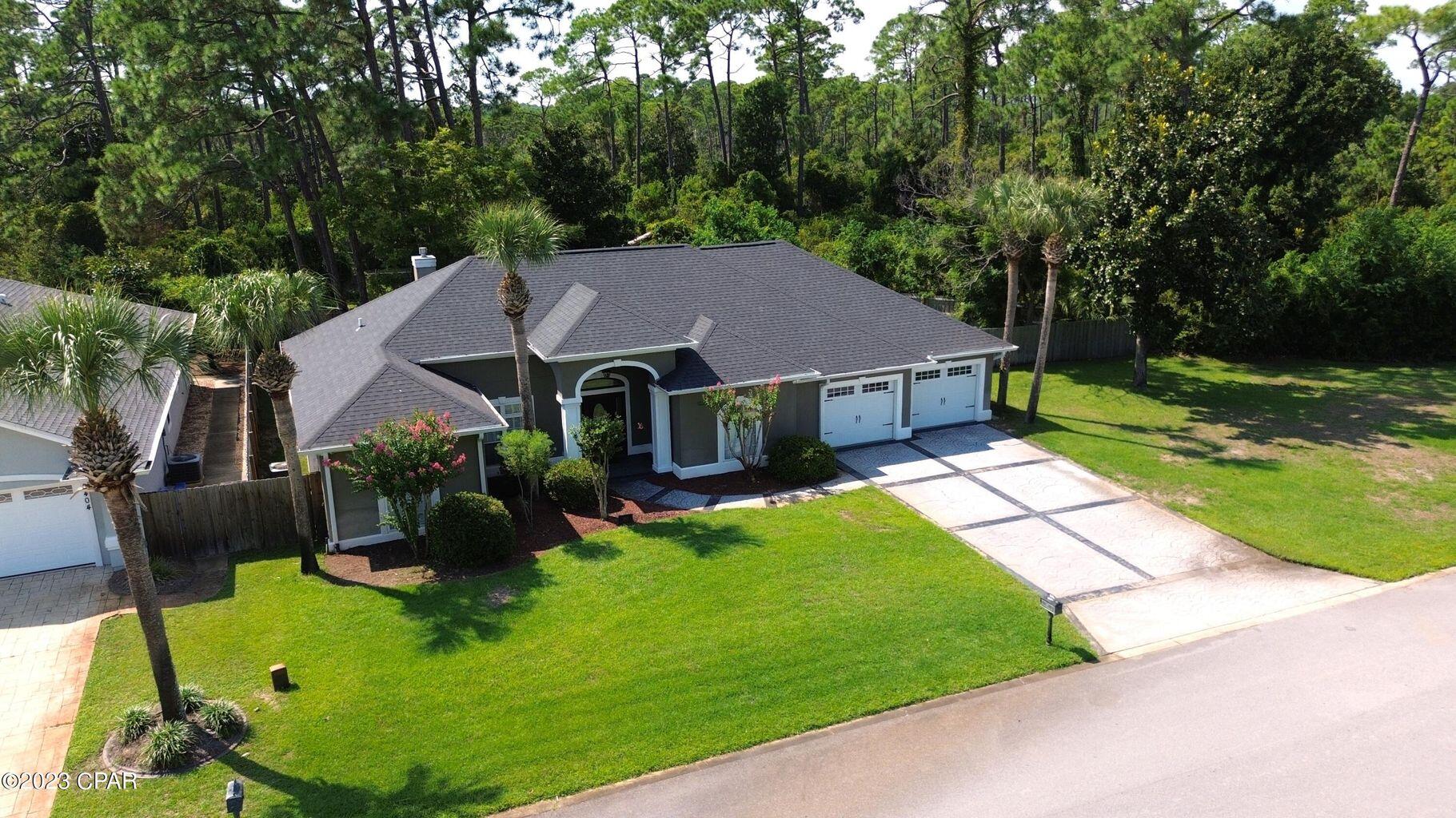 a aerial view of a house with swimming pool and green space