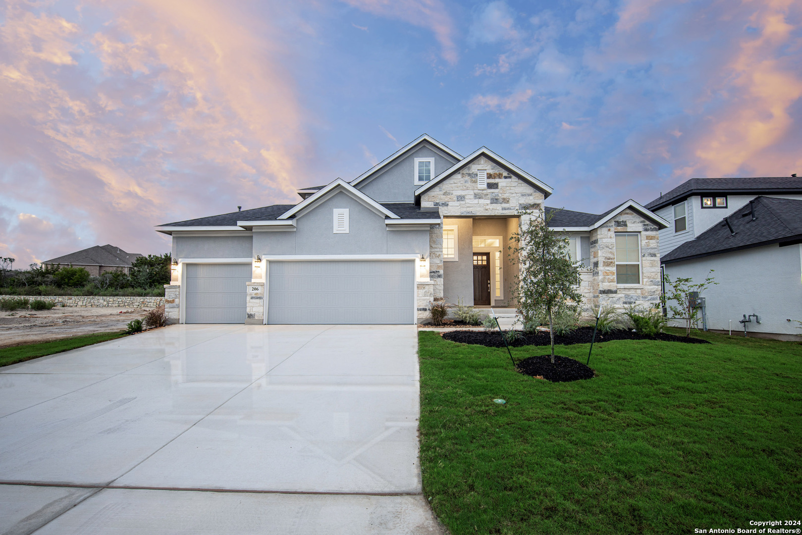 a front view of a house with a yard and garage