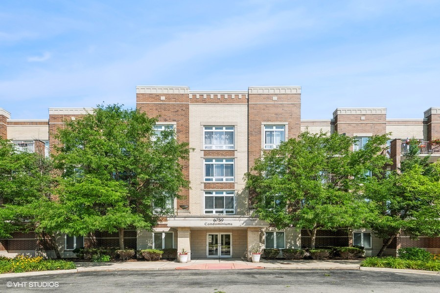 a front view of a residential apartment building with a yard