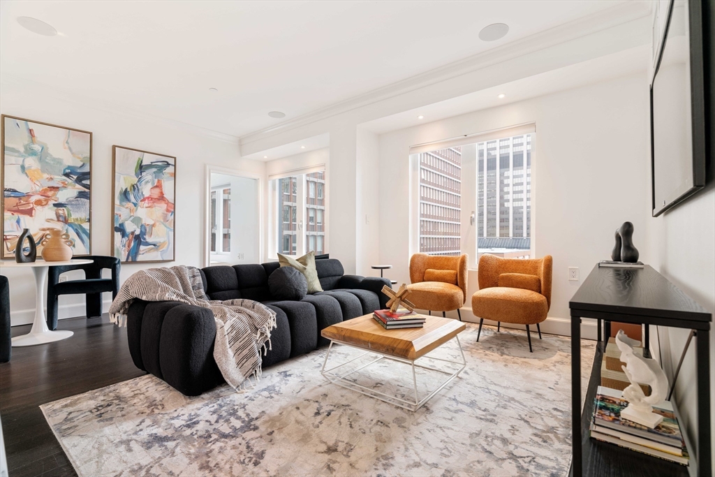 a living room with furniture ceiling fan and a window