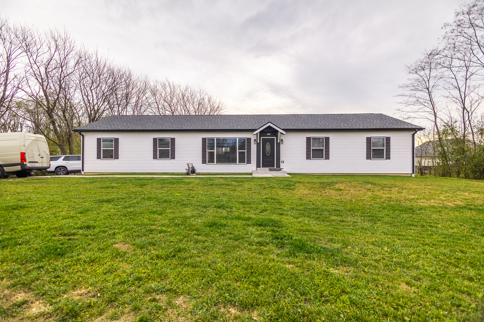 a front view of house with yard and green space