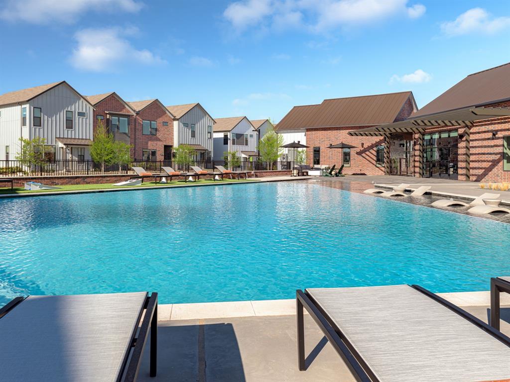 a view of a house with pool and a chairs