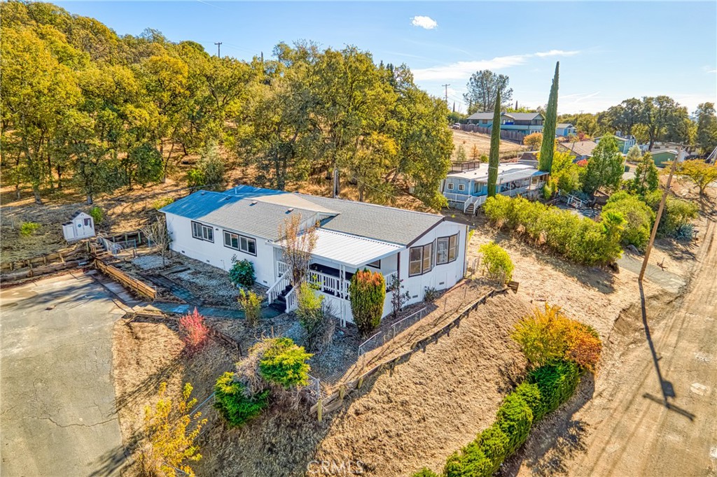 an aerial view of a house with large trees