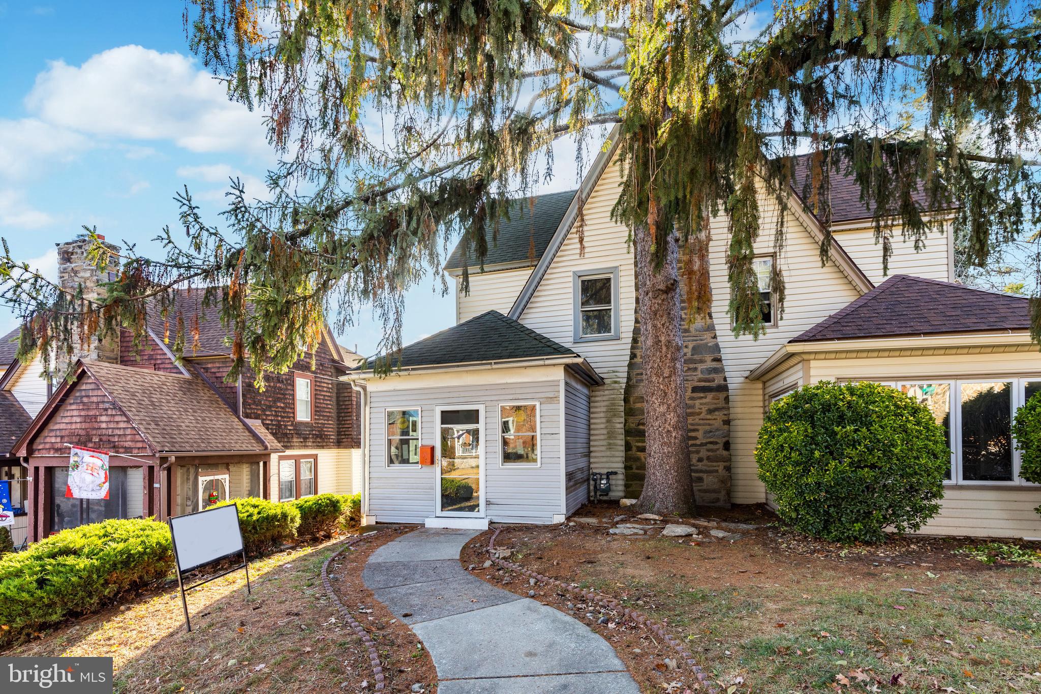 front view of a house with a tree in front