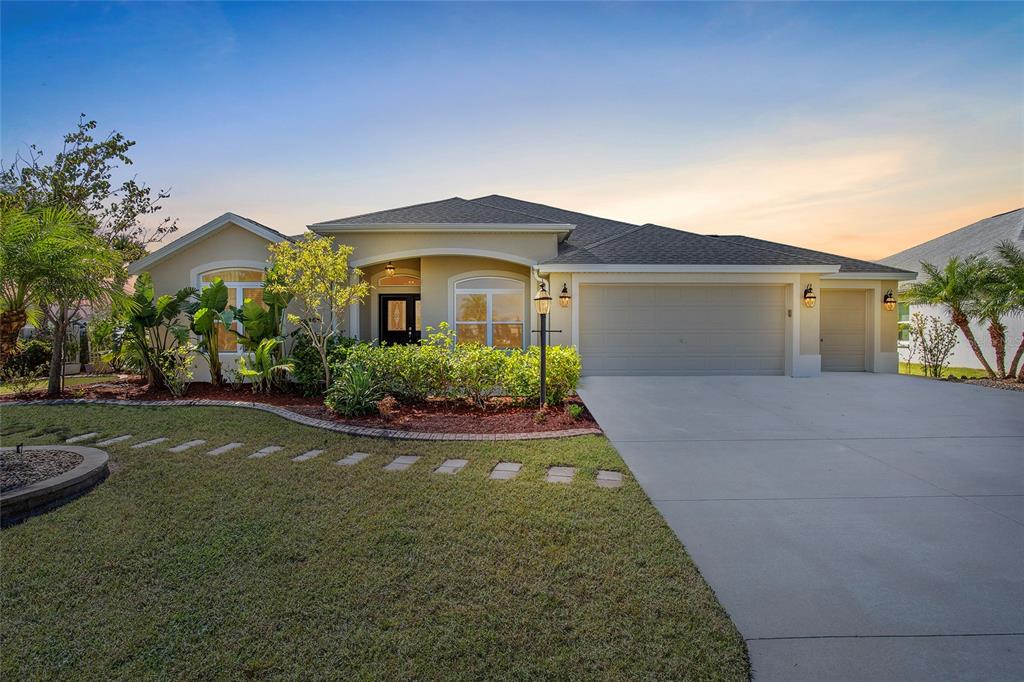 a front view of a house with a yard and garage