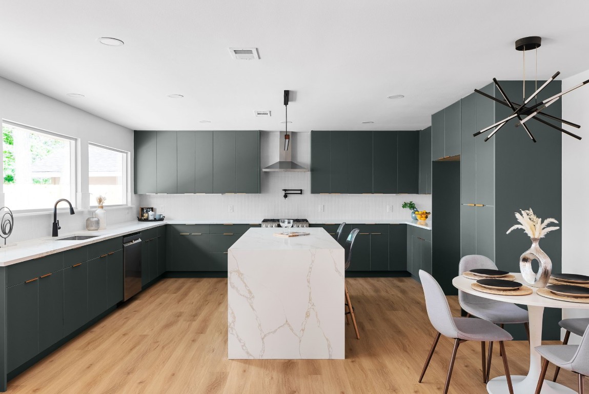 a kitchen with a sink cabinets and wooden floor