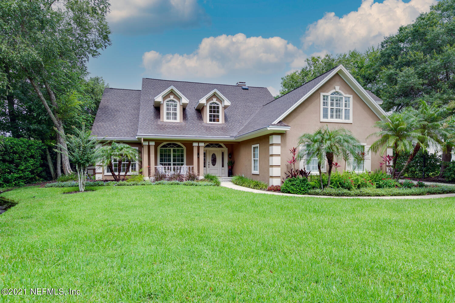 a front view of the house with garden