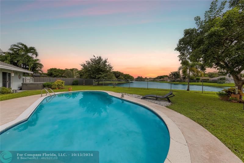 a view of a swimming pool and a yard