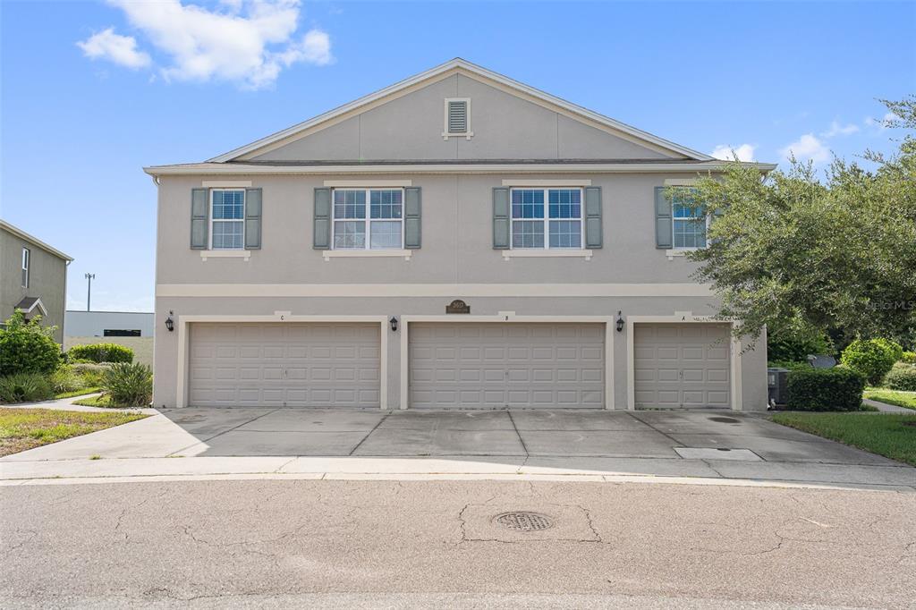 a front view of a house with a yard and garage