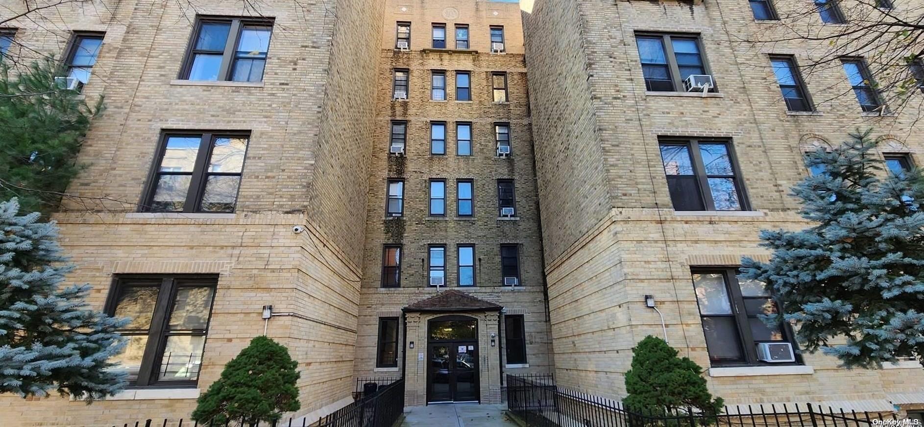 a front view of a building with plants