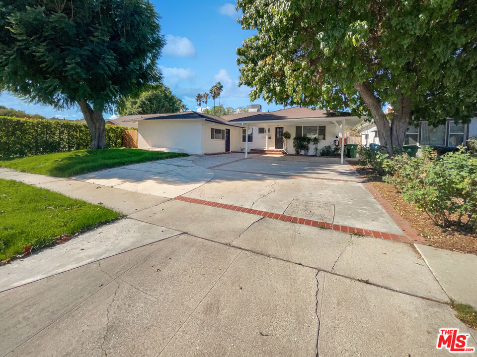 a front view of a house with a yard and a garage